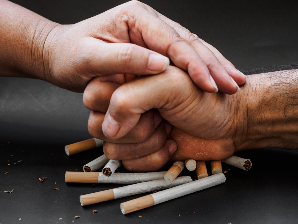 hand punching and destroying cigarettes