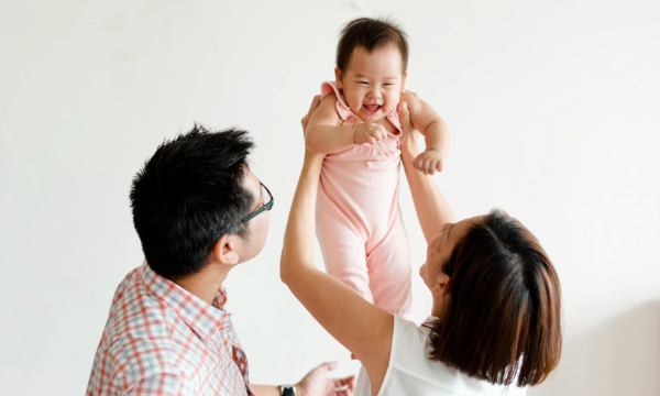 parents playing with their infant baby