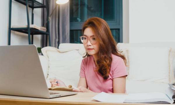 female wearing glasses while working on laptop