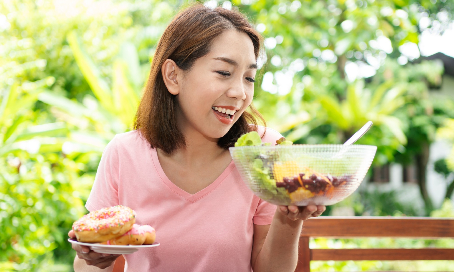woman looking at healthy food over donuts
