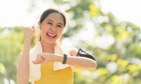 woman working out outside smiling